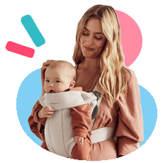 Mother holds baby in BabyBjorn carrier