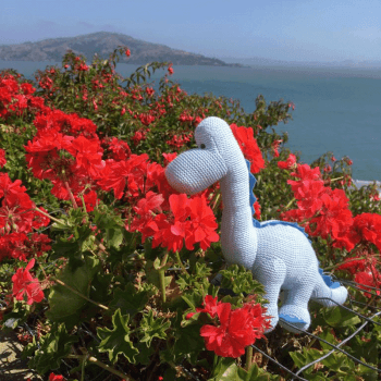 Image showing the Knitted Organic Cotton Blue Diplodocus Dinosaur Baby Rattle, Blue product.